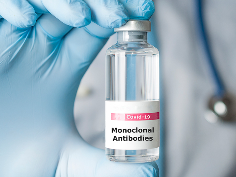 Doctor holding a vial of monoclonal antibodies, a new treatment for coronavirus Covid-19